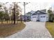 Two-story house with gray siding, white trim, and a large driveway at 18025 Nimick Rd, Weeki Wachee, FL 34614