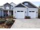 Front view of a house with a two-car garage and landscaped yard at 18025 Nimick Rd, Weeki Wachee, FL 34614