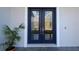 Double dark blue front doors with glass panels at 18025 Nimick Rd, Weeki Wachee, FL 34614