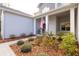 Front entry with a walkway, landscaping, and a blue door at 18025 Nimick Rd, Weeki Wachee, FL 34614