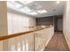 Upstairs hallway with a view to a sitting area and white railings at 18025 Nimick Rd, Weeki Wachee, FL 34614