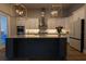 Modern kitchen with granite countertops and large island at 18025 Nimick Rd, Weeki Wachee, FL 34614