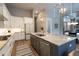 Bright kitchen with white cabinets, granite counters, and an island at 18025 Nimick Rd, Weeki Wachee, FL 34614