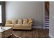 Living area with beige sofa and view of staircase at 18025 Nimick Rd, Weeki Wachee, FL 34614