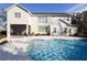 Luxury home with inviting pool and spa, expansive patio, and lush landscaping at 18025 Nimick Rd, Weeki Wachee, FL 34614