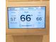 Digital thermostat displaying indoor and outdoor temperatures at 18025 Nimick Rd, Weeki Wachee, FL 34614