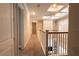 Bright upstairs hallway with carpeted floors and white railings at 18025 Nimick Rd, Weeki Wachee, FL 34614