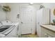 Laundry room with washer, dryer, and utility sink at 18028 Baywood Forest Dr, Hudson, FL 34667