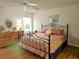 King-size bedroom with wood floors and decorative bedding at 18049 Tarrington Pl, Hudson, FL 34667