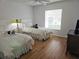 Bedroom with twin beds and wood floors at 18049 Tarrington Pl, Hudson, FL 34667
