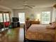 Spacious bedroom with king-size bed and wood floors at 18049 Tarrington Pl, Hudson, FL 34667