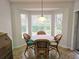 Bright breakfast nook with wicker chairs and a view of the backyard at 18049 Tarrington Pl, Hudson, FL 34667