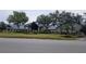 Community clubhouse with golf carts parked outside at 18049 Tarrington Pl, Hudson, FL 34667