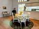 Dining room with white table and chairs, and floral tablecloth at 18049 Tarrington Pl, Hudson, FL 34667