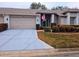 Two-car garage villa with American flag at 18049 Tarrington Pl, Hudson, FL 34667