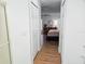 Hallway view of bedroom with wood floors at 18049 Tarrington Pl, Hudson, FL 34667