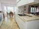 Kitchen with white cabinets, double sink, and tile countertops at 18049 Tarrington Pl, Hudson, FL 34667