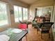 Bright sunroom with wicker furniture and view of backyard at 18049 Tarrington Pl, Hudson, FL 34667