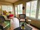 Relaxing sunroom with wicker furniture and access to the backyard at 18049 Tarrington Pl, Hudson, FL 34667
