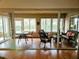 Bright sunroom with wicker furniture and tiled floor at 18049 Tarrington Pl, Hudson, FL 34667