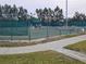Well-maintained tennis courts with surrounding fencing at 18049 Tarrington Pl, Hudson, FL 34667