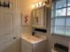 Bright bathroom featuring vanity, medicine cabinet, and window at 21103 Patio View Ct # 3105, Lutz, FL 33558