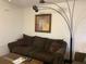 Living room with brown couch and floor lamp at 21103 Patio View Ct # 3105, Lutz, FL 33558