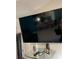 Wall-mounted TV with shelving below at 21103 Patio View Ct # 3105, Lutz, FL 33558