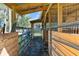 Wooden horse stalls with metal gates and wire fencing at 23051 Lake Lindsey Rd, Brooksville, FL 34601