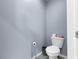 Small bathroom with toilet and pedestal sink at 23051 Lake Lindsey Rd, Brooksville, FL 34601