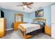 Bedroom with wood bed frame and ceiling fan at 23051 Lake Lindsey Rd, Brooksville, FL 34601