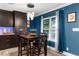 Charming dining area with dark wood table and blue walls at 23051 Lake Lindsey Rd, Brooksville, FL 34601