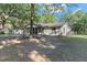 Ranch-style home with mature landscaping and driveway at 23051 Lake Lindsey Rd, Brooksville, FL 34601