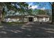 Ranch-style home with double front doors and landscaping at 23051 Lake Lindsey Rd, Brooksville, FL 34601