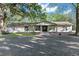 Ranch-style home with double front doors and landscaping at 23051 Lake Lindsey Rd, Brooksville, FL 34601