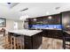 Modern kitchen with island, stainless steel appliances, and blue backsplash at 23051 Lake Lindsey Rd, Brooksville, FL 34601