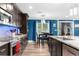 Modern kitchen with island, stainless steel appliances, and blue backsplash at 23051 Lake Lindsey Rd, Brooksville, FL 34601