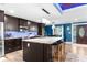 Modern kitchen with island, stainless steel appliances, and blue backsplash at 23051 Lake Lindsey Rd, Brooksville, FL 34601