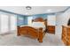 Large bedroom with wood furniture and access to doors at 23051 Lake Lindsey Rd, Brooksville, FL 34601
