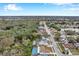 Aerial view of house with pool, showcasing neighborhood and surrounding landscape at 2643 Narcissus Dr, Holiday, FL 34691