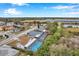 Aerial view of house with pool, showcasing neighborhood and surrounding landscape at 2643 Narcissus Dr, Holiday, FL 34691