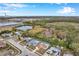 Aerial view showcasing a house with a pool and its surroundings at 2643 Narcissus Dr, Holiday, FL 34691