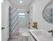 Updated bathroom, featuring a tub, shower, and stylish decor at 2643 Narcissus Dr, Holiday, FL 34691