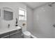 Modern bathroom with gray tile and a walk-in shower at 2643 Narcissus Dr, Holiday, FL 34691