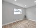 Light-filled bedroom showcasing wood-look floors and a window at 2643 Narcissus Dr, Holiday, FL 34691