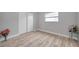 Bedroom featuring wood-look floors and a glass-top side table at 2643 Narcissus Dr, Holiday, FL 34691