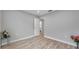 Spacious bedroom featuring wood-look floors and access to bathroom at 2643 Narcissus Dr, Holiday, FL 34691