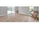 Bright bedroom with wood-look floors and pool view at 2643 Narcissus Dr, Holiday, FL 34691