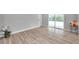 Bright bedroom with wood-look floors and sliding door closet at 2643 Narcissus Dr, Holiday, FL 34691