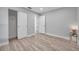 Bedroom with wood-look floors, sliding door closet, and an open doorway at 2643 Narcissus Dr, Holiday, FL 34691